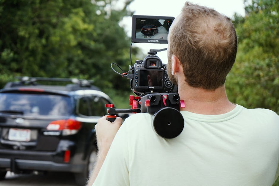 Professional wedding videographer filming a ceremony